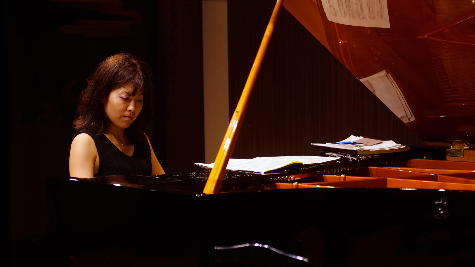 Pianist playing music in a small room.