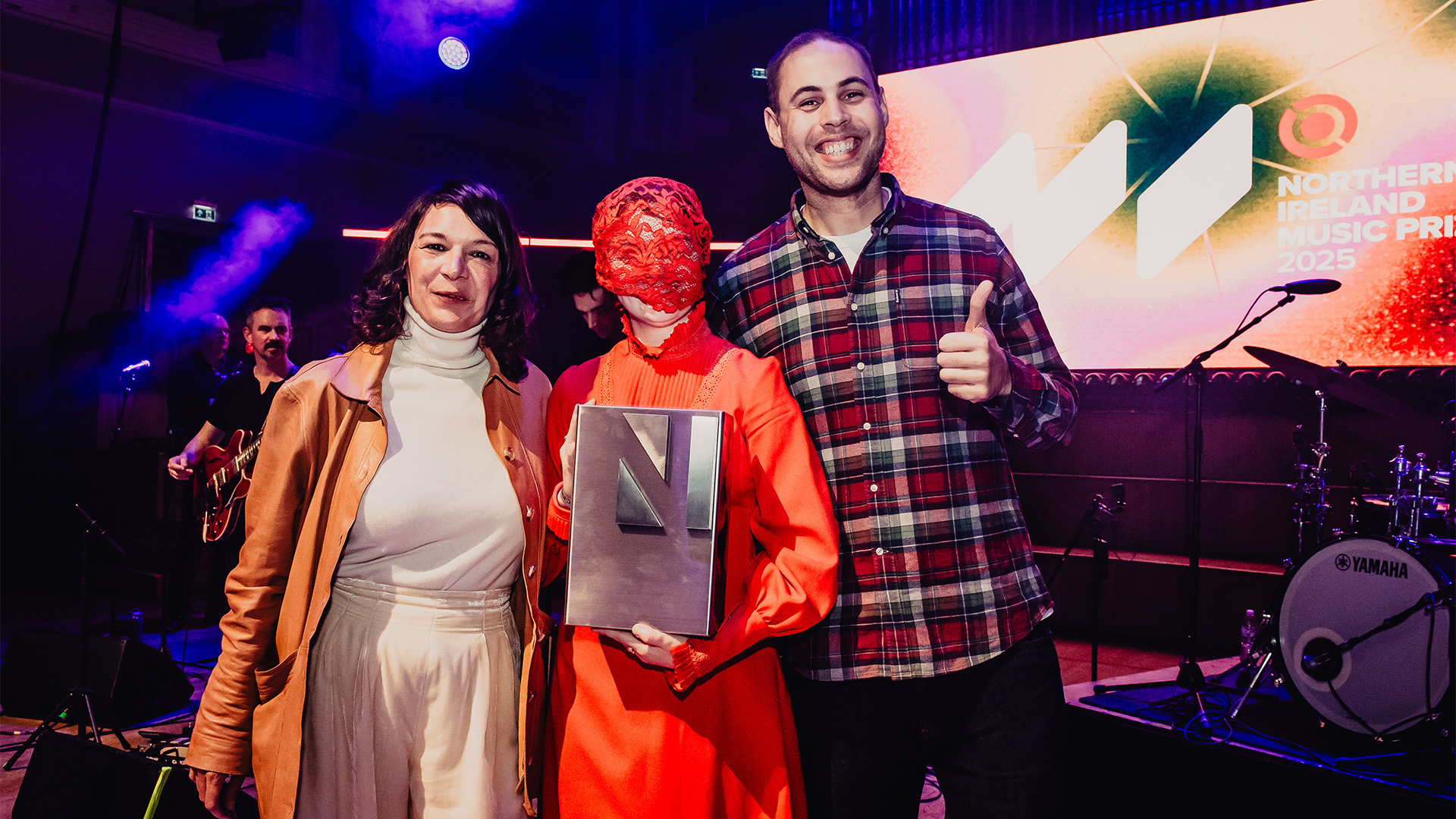 NI Music Prize 2025 winner Rois (centre) with Leo O'Brien (right) and Ruth Barlow (left).