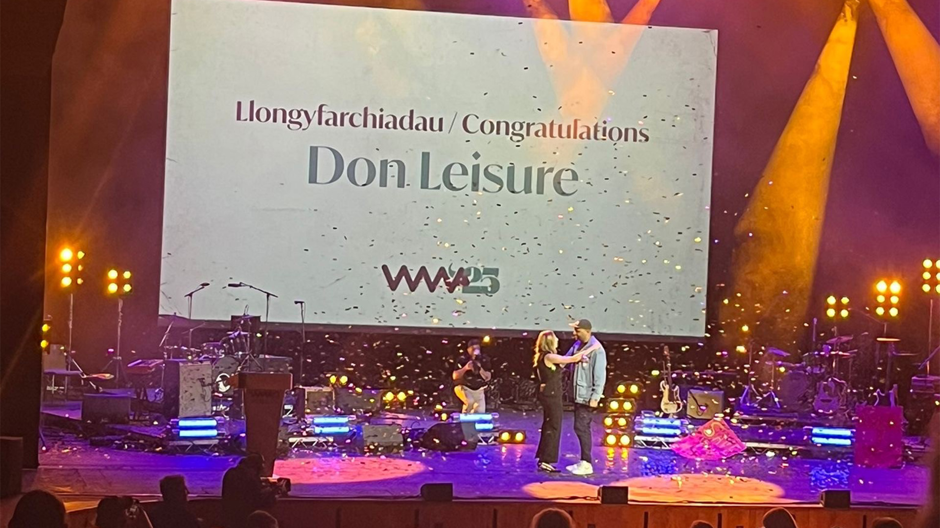Don Leisure on stage picking up the 2025 Welsh Music Prize.