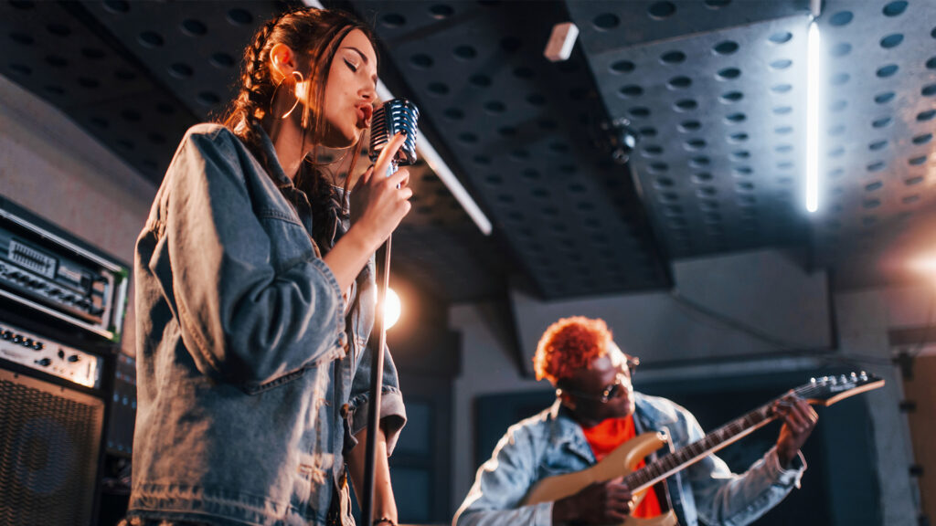 Singer and Guitar Player in recording studio