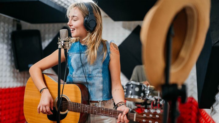 Female musician working in a recording studio.