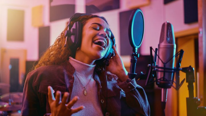 Woman singing in a studio for radio, song production and rehearsal. Creative, voice and singer making a record